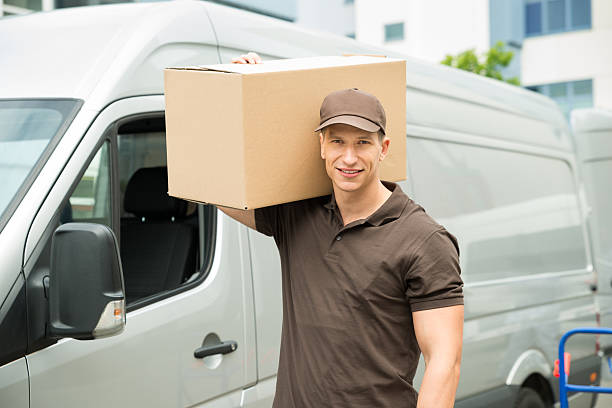 Young Happy Delivery Man Carrying Cardboard Boxes